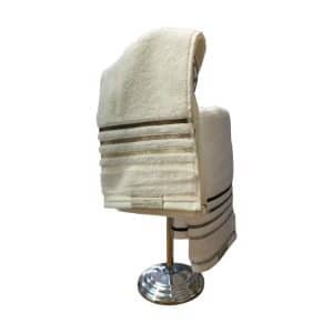 Dos toalla de mano Lumina en gamas de beige colgadas en un toallero